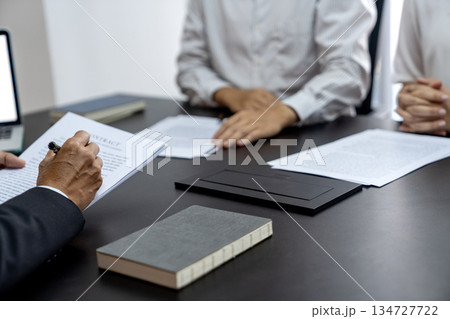 The lawyer is writing down the messages heard from the client to collect 134727722
