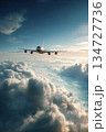 Elegant Airliner Soaring Above Clouds in Serene Blue Sky 134727736