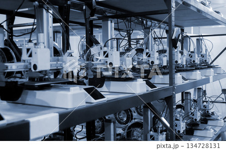 Many 3D printers printing object. 3D printers printing model from molten plastic. 3D printers creating shape from molten plastic flowing out of extruder. New modern 3D Printing additive technologies 134728131