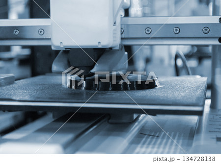 3D printer close up. Working 3D printer in process of printing object from molten black plastic. 3D printer creating model by flowing liquid plastic from extruder of printer. 3D printing technology 3D printer close up. Working 3D printer in process of printing object from molten black plastic. 3D printer creating model by flowing liquid plastic from extruder of printer. 3D printing technology 134728138