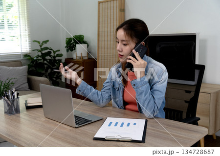 Businessman or freelancer in casual clothes using phone for work 134728687