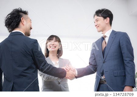 握手をするビジネスマン3人の契約、m&a、協業や協力成功のイメージ 握手をするビジネスマン3人の契約、m&a、協業や協力成功のイメージ 134728709
