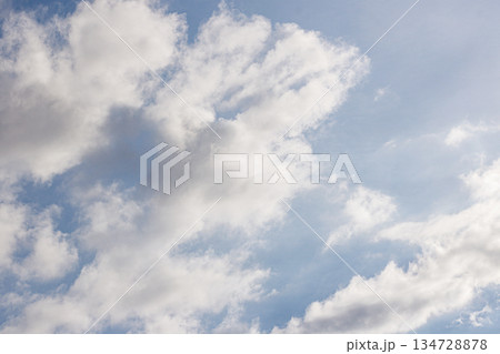 Bright Blue Sky with Fluffy White Clouds. Nature Background. Weather Concept. Heaven Atmosphere. High quality photo 134728878