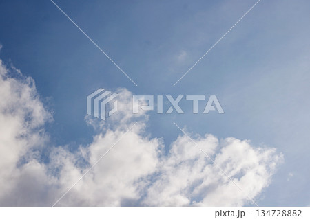 Blue Sky with Fluffy White Clouds. Cloudscape Atmosphere. Nature Background. Climate Concept. High quality photo Blue Sky with Fluffy White Clouds. Cloudscape Atmosphere. Nature Background. Climate Concept. High quality photo 134728882