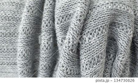 Soft gray knitted wool fabric texture background with detailed yarn pattern Soft gray knitted wool fabric texture background with detailed yarn pattern 134730826