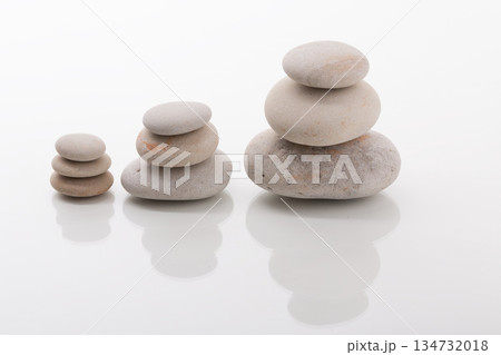Zen Stone Stacking: Three Balanced Cairns on White Background 134732018