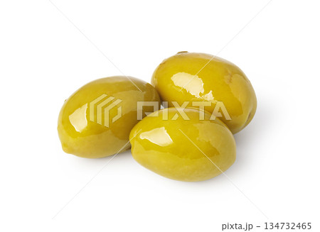 Three shiny green olives isolated on white background Three shiny green olives isolated on white background 134732465