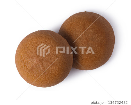 Two round brown snack cakes on white background Two round brown snack cakes on white background 134732482