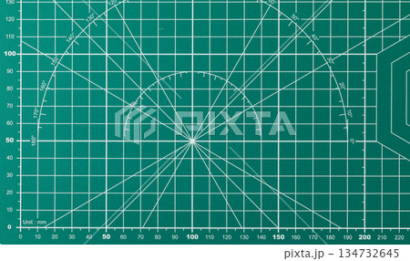 Green cutting mat with grid and measurement markings for precision work 134732645