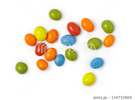Many chocolate coated candies scattering on white background 134732669