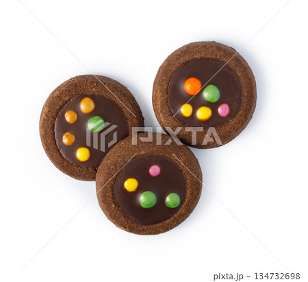 Three chocolate cookies with colorful candies top view 134732698