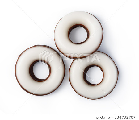 Three chocolate ring cookies with white icing coating 134732707