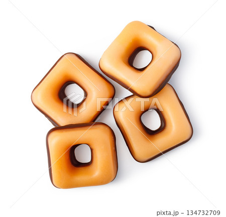 Caramel chocolate candies with square shape and hole 134732709