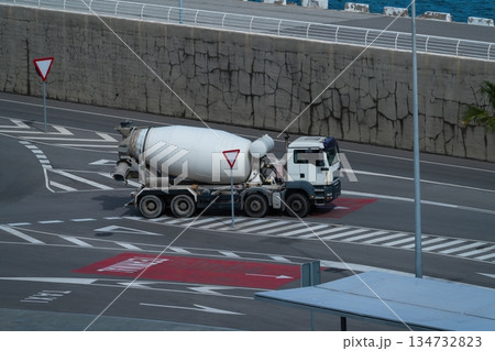 Concrete mixer truck driving on port road seen from above Concrete mixer truck driving on port road seen from above 134732823
