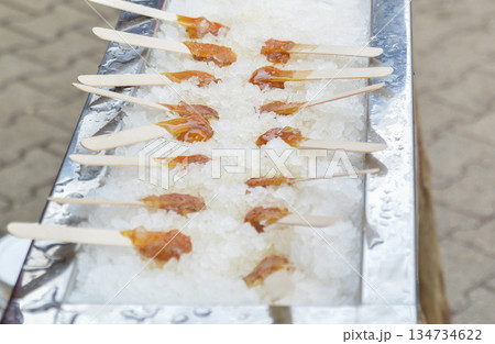 Hot maple syrup on a stick in the snow Hot maple syrup on a stick in the snow 134734622