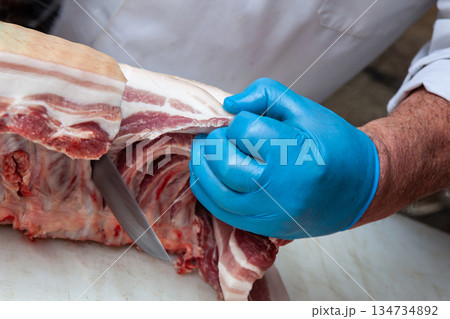 Professional gesture in a butchery shop 134734892