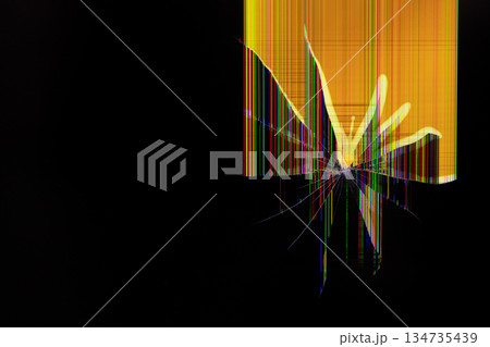 Broken screen with vibrant colorful vertical lines and radiating glass cracks against a dark background, symbolizing digital malfunction or technology error 134735439