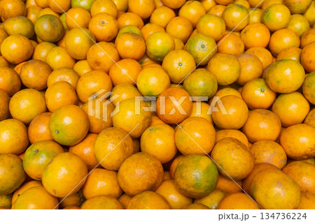 Fresh ripe oranges piled together in a local market Fresh ripe oranges piled together in a local market 134736224