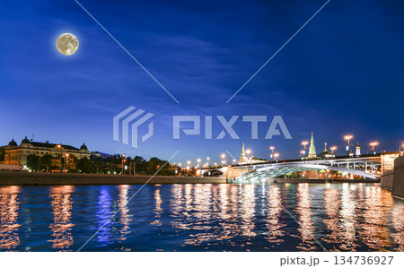 Night view of the Moskva River and Kremlin, Russia, Moscow (most popular view). Against the background of a beautiful sky with clouds, with the moon 134736927