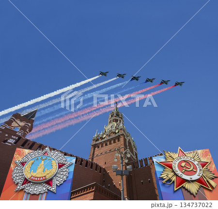 Moscow Kremlin (with decorations of Victory Day celebration (WWII), and Russian military aircraft with painted russian flag, Russia. TRANSLATION: USSR, Victory!, Patriotic war, May 9 134737022