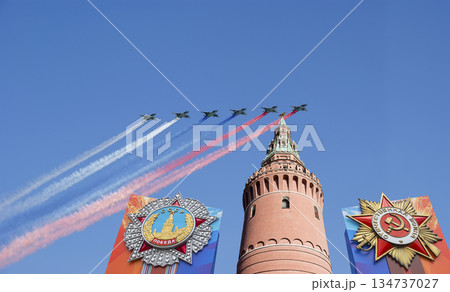 Moscow Kremlin (with decorations of Victory Day celebration (WWII), and Russian military aircraft with painted russian flag, Russia. TRANSLATION: USSR, Victory!, Patriotic war, May 9 Moscow Kremlin (with decorations of Victory Day celebration (WWII), and Russian military aircraft with painted russian flag, Russia. TRANSLATION: USSR, Victory!, Patriotic war, May 9 134737027