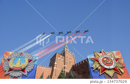 Moscow Kremlin (with decorations of Victory Day celebration (WWII), and Russian military aircraft with painted russian flag, Russia. TRANSLATION: USSR, Victory!, Patriotic war, May 9 134737029