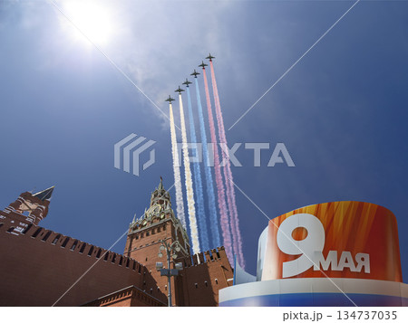Moscow Kremlin (with decorations of Victory Day celebration (WWII), and Russian military aircraft with painted russian flag, Russia. TRANSLATION: USSR, Victory!, Patriotic war, May 9 134737035