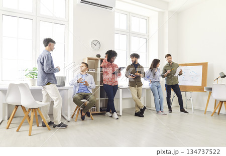 Business Team Communicating During Office Meeting or Presentation 134737522