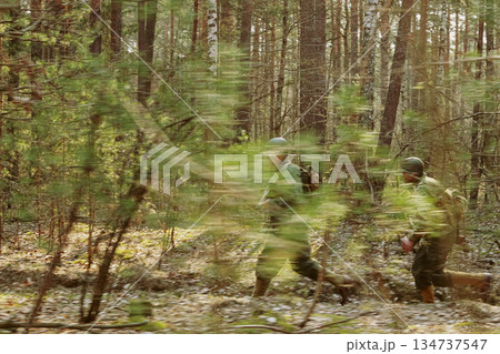 American Soldiers Of USA Infantry Of World War II Marching Running Run Along Forest In Autumn Spring Day. Group of soldiers 134737547