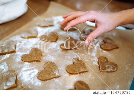 making heart-shaped gingerbread cookies making heart-shaped gingerbread cookies 134739753