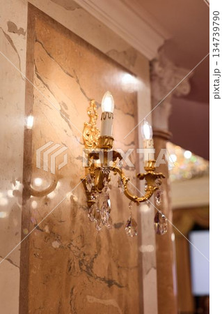 Classical Hotel Hallway Detail Showcasing Gilded Sconce With Candle Bulbs And Refined Craftsmanship Classical Hotel Hallway Detail Showcasing Gilded Sconce With Candle Bulbs And Refined Craftsmanship 134739790