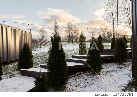 Winter landscape featuring elegant cabin and inviting outdoor arrangement 134739791