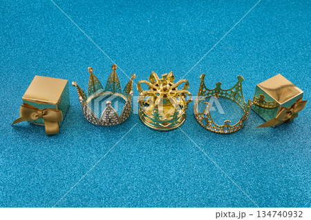 Three golden crowns representing epiphany and three wise on glitter background 134740932