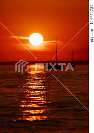 Sailing regatta in the Gulf of Finland at sunset, few sailing yachts competing in a race, splashing water from under the boats, teamwork, board the boat 134742789
