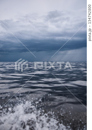 Sailing regatta in the Gulf of Finland in heavily rain, few sailing yachts competing in a race, splashing water from under the boats, teamwork, board the boat Sailing regatta in the Gulf of Finland in heavily rain, few sailing yachts competing in a race, splashing water from under the boats, teamwork, board the boat 134742800