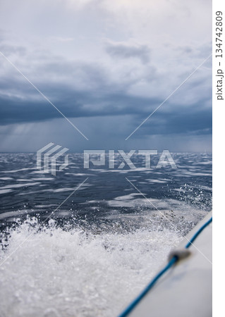 splashing water from under the rubber boat in stormy weather, sailing regatta in the Gulf of Finland in heavily rain 134742809