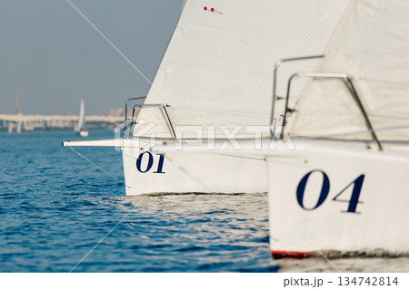bow of a sailing boats with bowsprit at sailing regatta in the Gulf of Finland at sunny day, sailing yacht competing in a race, splashing water from under the boat, teamwork, board the boat bow of a sailing boats with bowsprit at sailing regatta in the Gulf of Finland at sunny day, sailing yacht competing in a race, splashing water from under the boat, teamwork, board the boat 134742814