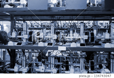 Many 3D printers printing object. 3D printers printing model from molten plastic. 3D printers creating shape from molten plastic flowing out of extruder. New modern 3D Printing additive technologies 134743047