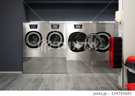 Modern Self-Service Laundromat with Industrial Washing Machines Modern Self-Service Laundromat with Industrial Washing Machines 134743085