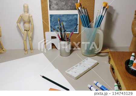 Artist studio desk with drawing tools and supplies 134743129