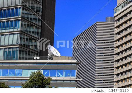 the satellite dish antennas for communication on top of modern skyscraper. the satellite dish antennas for communication on top of modern skyscraper. 134743139