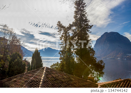 Awe view on red tiled roofs  and lake Lugano 134744142