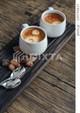 Two cups of coffee on wooden tray Two cups of coffee on wooden tray 134745617