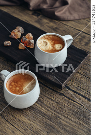 Two cups  of coffee on wooden tray 134745618