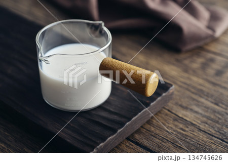 Milk in measuring glass cup 134745626