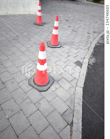 Traffic cones with reflective stripes are elements of road safety, traffic management or parking Traffic cones with reflective stripes are elements of road safety, traffic management or parking 134746685
