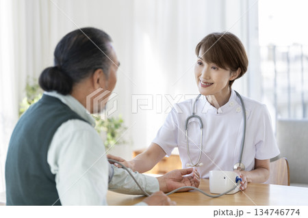 シニア男性の血圧を測る医療スタッフ シニア男性の血圧を測る医療スタッフ 134746774