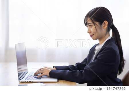 パソコンで作業するスーツを着た若い女性 134747262