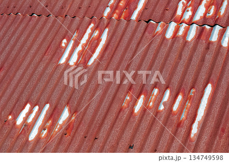 Rusty Corrugated Metal Surface Texture Showing Wear and Tear, Creating Weathered Look for Industrial or Vintage Background Applications 134749598