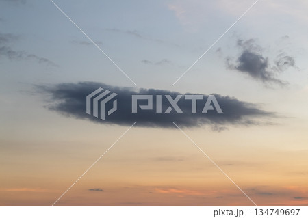 Dramatic sky with dark cloud formations during golden hour for weather concept, natural light and ample copy space, inspiring backdrop Dramatic sky with dark cloud formations during golden hour for weather concept, natural light and ample copy space, inspiring backdrop 134749697